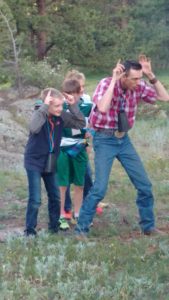 Dude ranch cowboy campfire at affordable all-inclusive colorado family adventure vacation