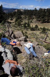 Guests sunbathe on the rocks