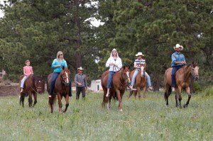 Riders head across the field to go swimming