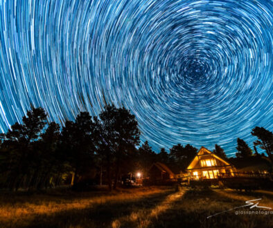 Star trails swirl above the main lodge at Sundance Trail Guest Ranch, capturing the beauty of the Colorado night sky.