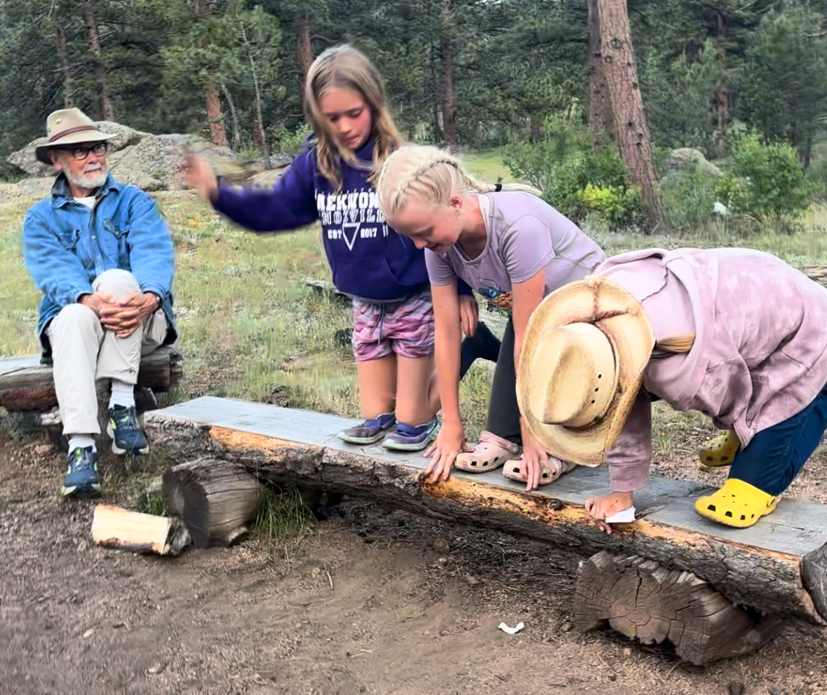 sundance-trail-guest-ranch-vacation-with-grandkids Grandpa watches his granddaughters having fun at the ranch